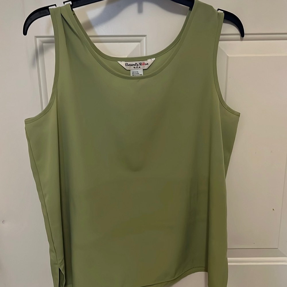 Sleeveless top .  Greenish color . Size M.  Polyester . Soft, satin feel